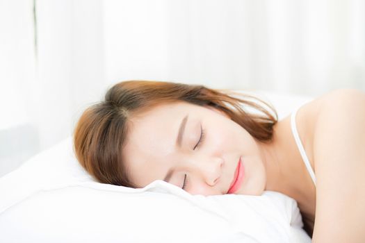 Beautiful asian young woman sleeping lying in bed with head on pillow comfortable and happy. girl with relax for health concept.