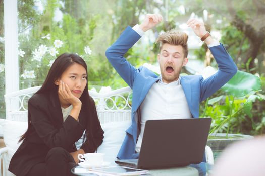 Two business surprised looking at laptop computer with shocked, businessman and businesswoman contract with excited in meeting teamwork.