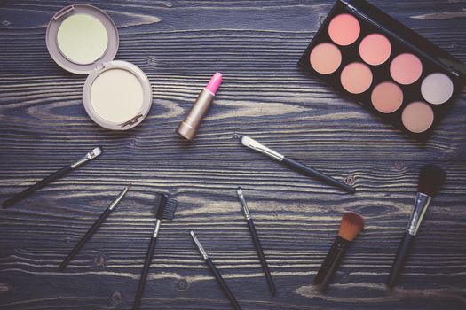 Top view a collection of cosmetic makeup on wooden table background, products cosmetic fashion concept, vintage retro style.