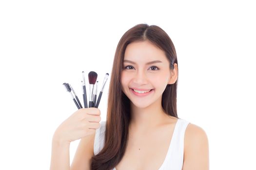 Beauty asian woman applying make up with brush on hand isolated on white background, beautiful of girl holding blusher, skincare and cosmetic concept.