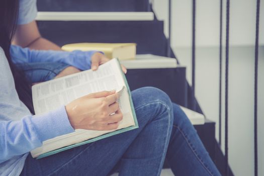 Closeup couple asian handsome man and beautiful woman reading book and glad at home, boyfriend and girlfriend with activities together for leisure, education success concept.