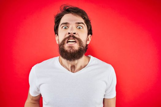 man in t-shirt gesturing with his hands dissatisfaction studio red uniform. High quality photo