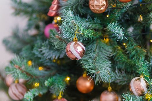 Beautiful Christmas tree decorated with colorful toys and garlands. New Year atmosphere.