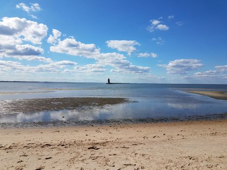 water and sand and lighthouse at ocean or sea