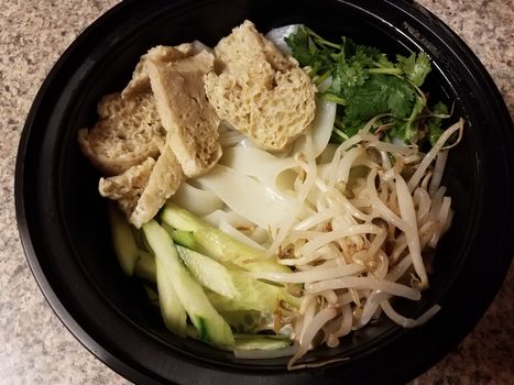 bowl of asian tofu and noodles and vegetables