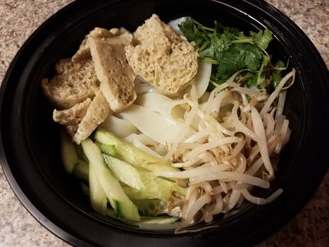 bowl of asian tofu and noodles and vegetables