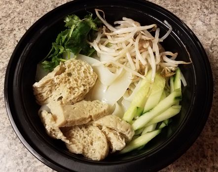 bowl of asian tofu and noodles and vegetables