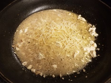 brown sauce with butter and cheese in skillet or frying pan