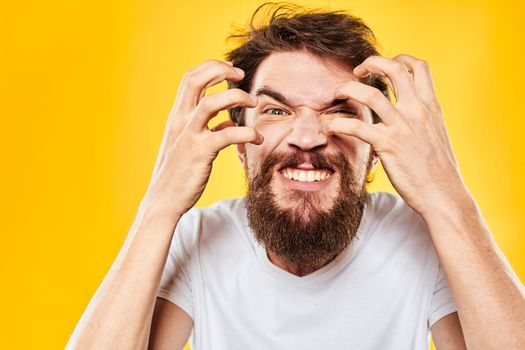 bearded man gesturing with hands studio lifestyle discontent yellow background. High quality photo