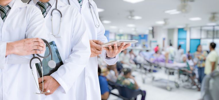 Team doctor held a tablet and a stethoscope In the treatment of patients
