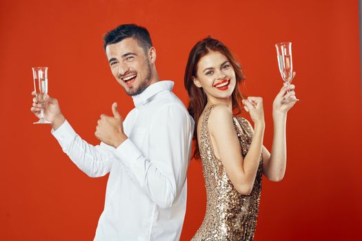 Cheerful men and women from the holiday champagne holiday corporate night club Red background