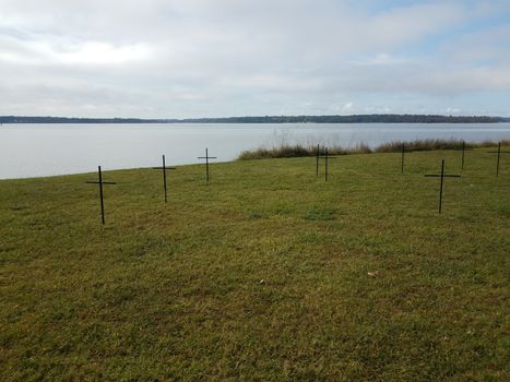 crosses on green grass or lawn near river water