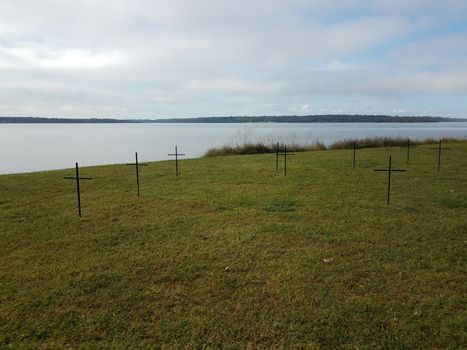 crosses on green grass or lawn near river water