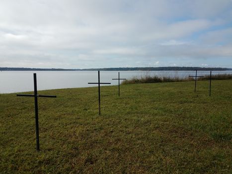 crosses on green grass or lawn near river water