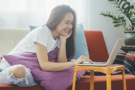 Attractive young Asia woman working at home. Working and learning from home.

