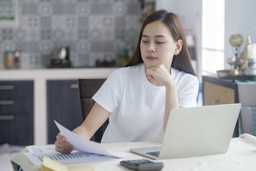 Attractive young Asia woman working at home. Working and learning from home.


