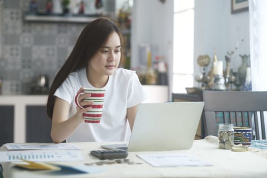 Attractive young Asia woman working at home. Working and learning from home.

