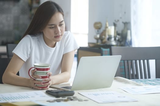 Attractive young Asia woman working at home. Working and learning from home.

