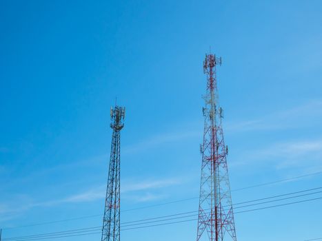 Telephone tower On the background is a bright blue sky.