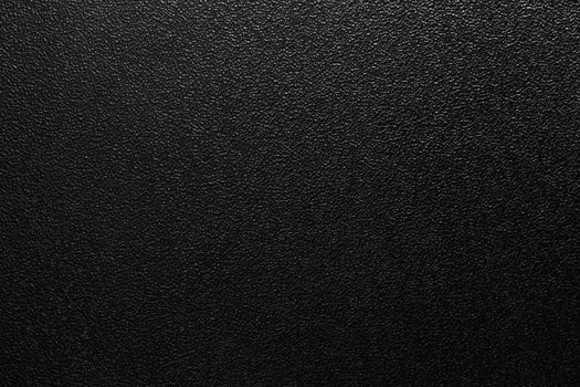 Dark full frame background of hammered powder paint coating on flat sheet steel surface. Also known as hammertone effect.