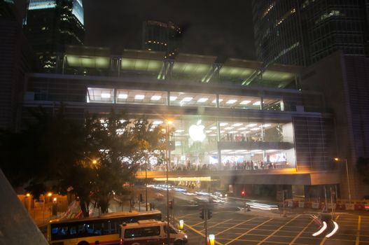 HONG KONG, HONG KONG SAR - NOVEMBER 17, 2018: Bright shiny Apple store in Central Hong Kong at night. There are many people inside the store.