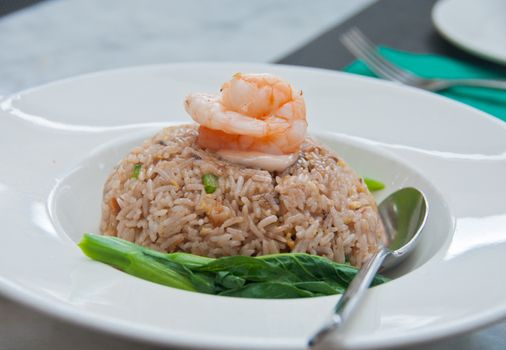 Traditional Asian fried rice with shrimp paste sauce topiing with giant tiger prawn in luxury Asian restaurant