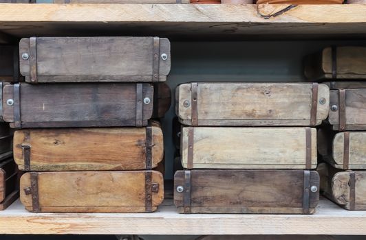 Vintage wooden crates in a shelf for sale in a small shop