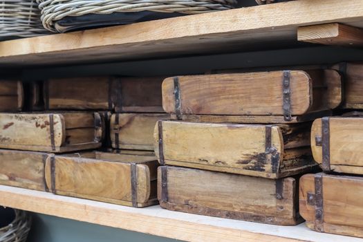 Vintage wooden crates in a shelf for sale in a small shop