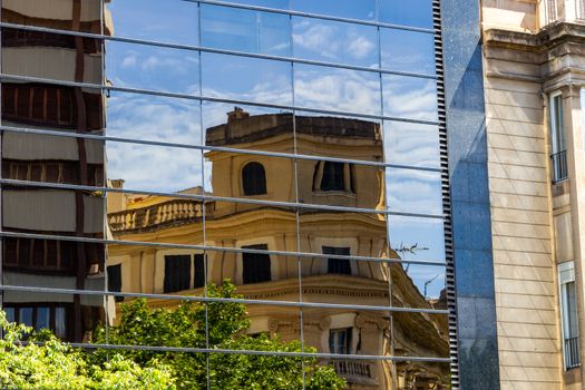 Reflection of an older building in  a window pane in Palma on balearic island Mallorca, Spain on a sunny day