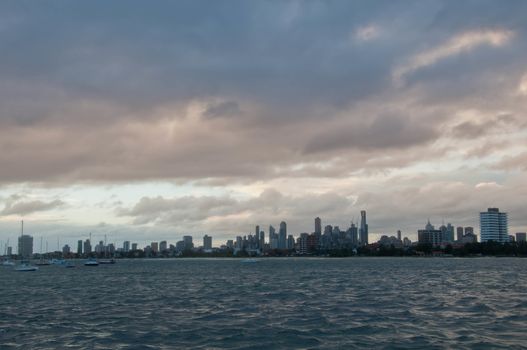 Wide angle evening scene of skyscrapers horizon with ocean and tall office and residential towers in Melbourne Australia