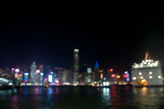 Light blur motion scene defocused modern building lights at night with ocean bay