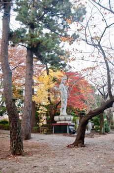 TOKYO, JAPAN - DECEMBER 1, 2018: Zojo-ji Buddhist temple. This is a famous temple which has the oldest wooden main gate in Tokyo built from 1622. There is a lady of mercy Buddhism statue in the temple park.