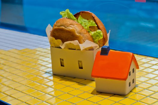 Freshly made burger fast food with soft toy orange house model