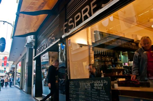 MELBOURNE, AUSTRALIA - JULY 26, 2018: Shoppers and diners walking to coffee shop in Degraves Street in Melbourne Australia