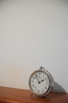 Classic vintage golden clock on a table with copyspace