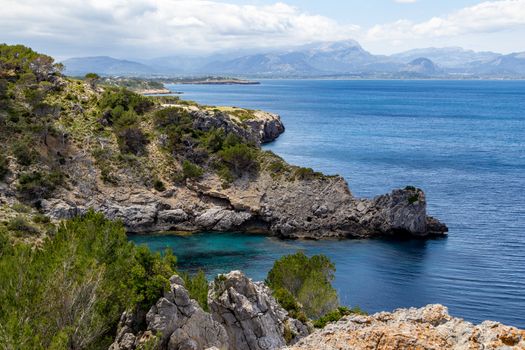 Bay Ses Caletes on the peninsula La Victoria, Mallorca with rocky coastline and turquoise clear water