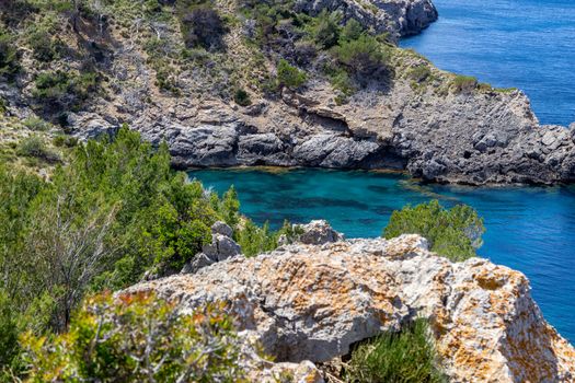 Bay Ses Caletes on the peninsula La Victoria, Mallorca with rocky coastline and turquoise clear water