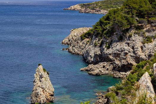 Bay Ses Caletes on the peninsula La Victoria, Mallorca with rocky coastline and turquoise clear water