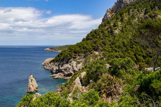 Bay Ses Caletes on the peninsula La Victoria, Mallorca with rocky coastline and turquoise clear water