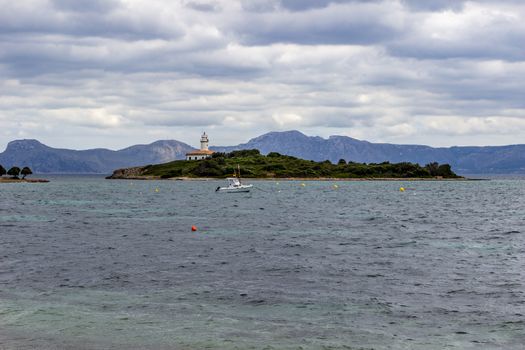 Scenic view from the peninsula La Victoria, Mallorca with island and mountain range in the background