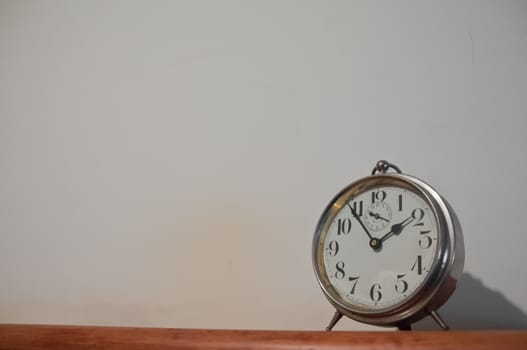 Classic vintage golden clock on a table with copyspace