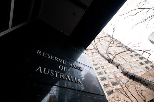 MELBOURNE, AUSTRALIA - JULY 26, 2018: Reserve Bank of Australia name on black granite wall in Melbourne Australia with a reflection of high-rise buildings. The RBA building is located at 60 Collins St, Melbourne VIC 3000 Australia.