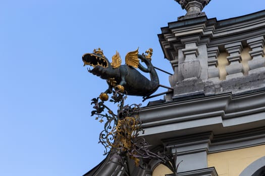 Scultpure of a dragon with golden crown and golden wings on a building in St. Blasien, Black Forest, Germany