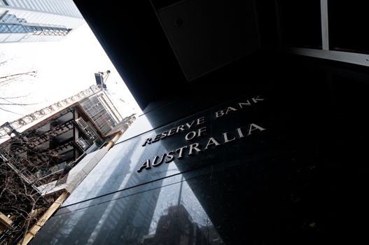 MELBOURNE, AUSTRALIA - JULY 26, 2018: Reserve Bank of Australia name on black granite wall in Melbourne Australia with a reflection of high-rise buildings. The RBA building is located at 60 Collins St, Melbourne VIC 3000 Australia.