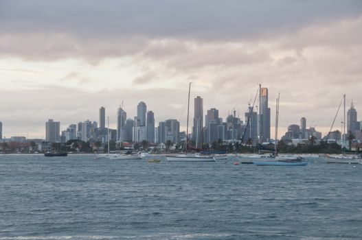 Wide angle evening scene of skyscrapers horizon with ocean and tall office and residential towers in Melbourne Australia