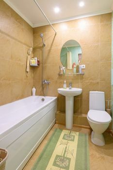 Interior of an ordinary standard classic bathroom joint with a toilet