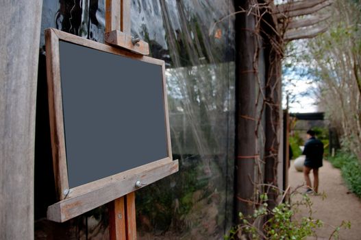 Black wooden frame board in a garden