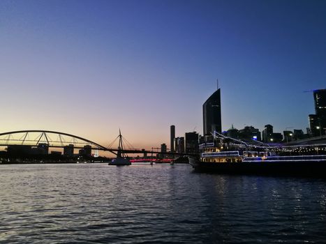 BRISBANE, AUSTRALIA - AUGUST 4, 2018: Peaceful twilight scene of Brisbane river sunset with a restaurant ferry. There is nobody in the photo.