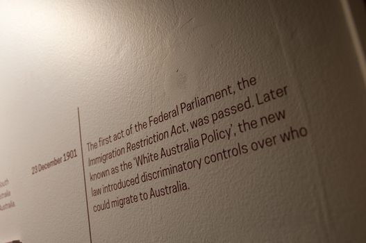 MELBOURNE, AUSTRALIA - JULY 26, 2018: White Australia Policy on 23 December 1901 explanation text on white wall