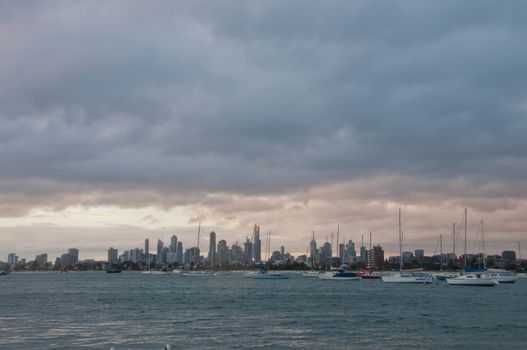 Wide angle evening scene of skyscrapers horizon with ocean and tall office and residential towers in Melbourne Australia